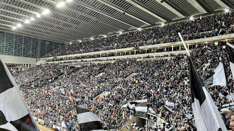 fans waving scarves pre match milburn stand sjp newcastle united nufc 1120 768x432 4